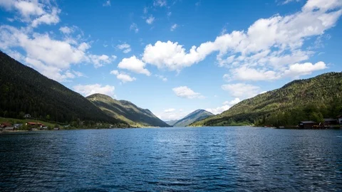 Time lapse - Moving clouds above a lake in the mountains / alps Stock Footage 99373342