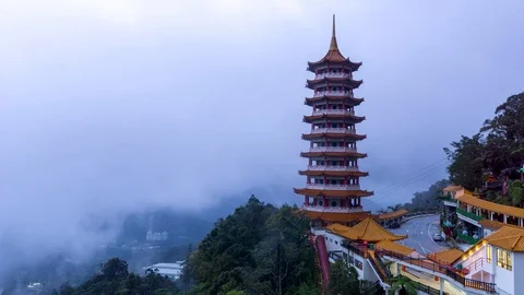 Time lapse of moving clouds and fog over Chin Swee Caves Temple in Malaysia Stock Footage 86957248