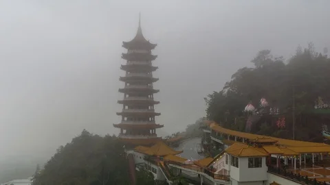 Time lapse of moving clouds and fog over Chin Swee Caves Temple in Malaysia Stock Footage 86957655