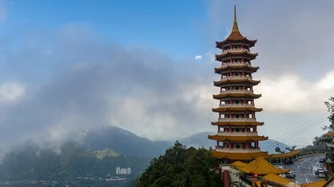 Time lapse of moving clouds and fog over Chin Swee Caves Temple in Malaysia Stock Footage 86964868