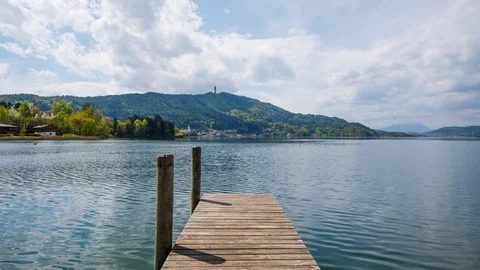 Time Lapse - Moving clouds and moving water at a pier at the lake Видео 99367620