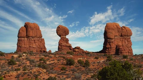 Time lapse of moving clouds and sky over Balanced Rock formation in Arches Stock Footage 344451435