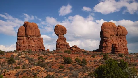 Time lapse of moving clouds and sky over Balanced Rock formation in Arches Stock Footage 345177390