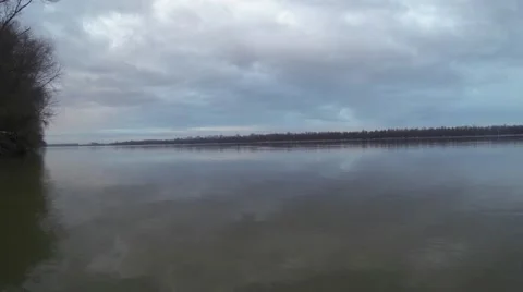 Time lapse moving clouds are over the river. Video stock 46137028