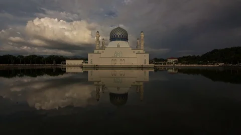 Time-lapse of moving clouds during sunset at Likas Mosque Stock Footage 77784672