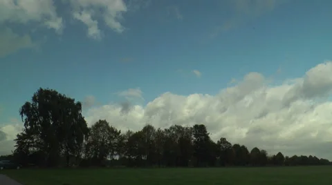 Time lapse of moving clouds in green landscape Stock Footage 32109629