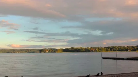 Time-lapse of moving clouds in a lake in karlskoga Sweden at sunset Stock Footage 134655800
