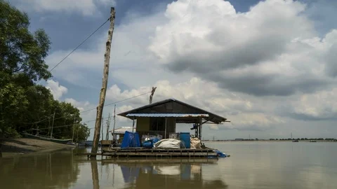 Time lapse moving clouds motion and floating wood house at Port Klang jetty Stock Footage 105986218