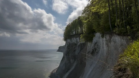 Time lapse of moving clouds next to the chalk cliffs on the German island Ruegen Stock Footage 129772825