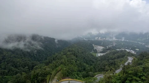 Time lapse of moving clouds over road between rain forest Stock Footage 86966722