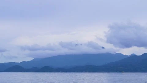 Time lapse moving clouds over mountain sea sunrise sky landscape in Indonesia Stock Footage 231745053