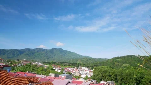 Time lapse moving clouds over mountain with resident housing at valley in I.. Stock Footage 231745134