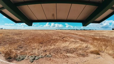 Time Lapse with Moving Clouds Over Dry Field Viewed from Under a Patio Cover Stock Footage 318335321