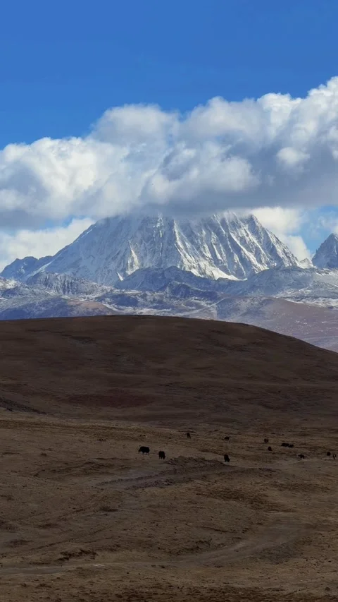 Time-lapse of Moving Clouds Over the Majestic Yala Snow Mountain in Tibet, S Stock Footage 329143121