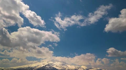 Time-lapse of Moving Clouds Over Snowy Mountains Stock Footage 333247768