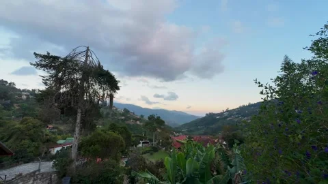 Time-lapse of Moving Clouds over a Lush Mountain Valley at Sunset Stock Footage 334091285