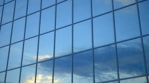 Time lapse moving clouds reflected in the windows of the skyscraper Stock Footage 12626224
