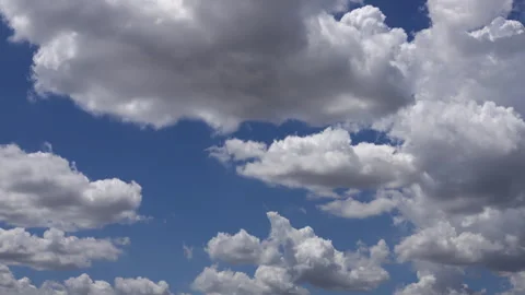 Time-lapse of moving fluffy clouds and white cumulus clouds in the blue sky.. Stock Footage 314981437