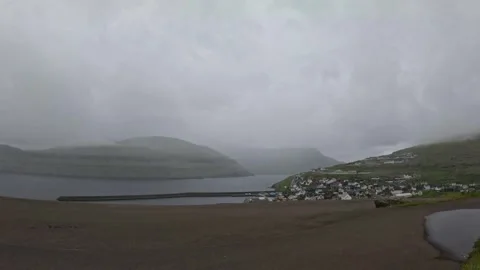 Time-lapse of moving fog and clouds over Glyvrar village, Faroe Islands Stock-Footage 339940978