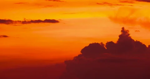 Time lapse of moving lumpy clouds in a golden sunset sky Stock Footage 221886516