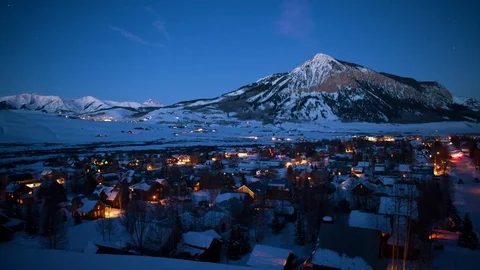Time-lapse of moving vehicles, illuminated houses and snow covered mountains Stock Footage 113266172