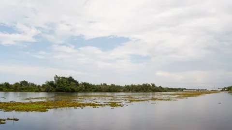 Time lapse of moving white cloud over rural lake Video stock 42756463