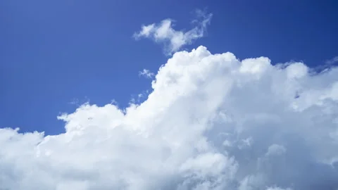 Time lapse of moving white clouds against deep blue sky Stock Footage 218453031