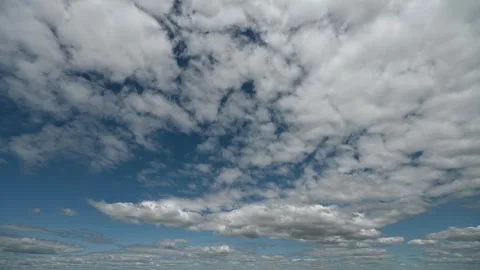 Time lapse of moving white summer clouds in a blue sky.  Stock Footage 246865161