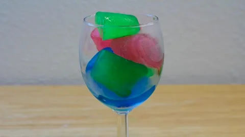 Time Lapse of Multi Colored Ice Melting in Wine Glass Video stock 1203061