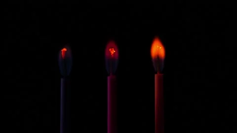 Time lapse of multicoloured small birthday candles burning on black background Stock Footage 138917400