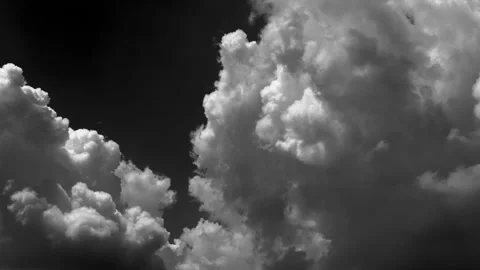 Time-lapse of multiple white clouds moving across a black background Vidéo 330886442