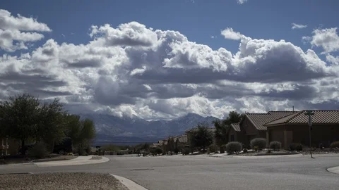 Time lapse of a neighborhood with clouds and majestic mountains in the distance Stock Footage 103233580