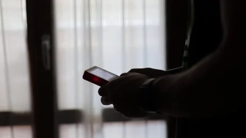 Time lapse: nerd plays with a little red retro video game. Male game player Stock Footage 136855741