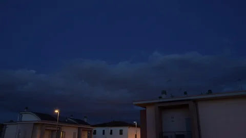 Time Lapse at night of Clouds on Downtown's houses Stock Footage 129271181