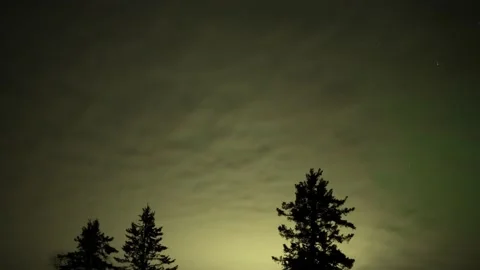 Time lapse of night clouds lit by a nearby town move towards the viewer Stock Footage 232821003