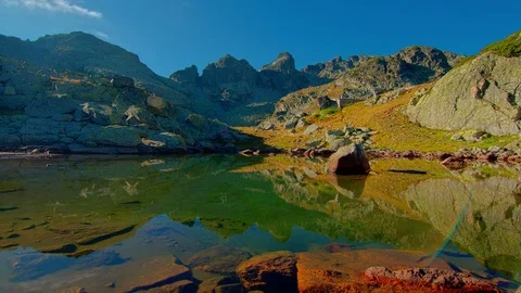 Time lapse night to day above mountain lake and peaks, stars to sunrise. Stock Footage 80165900