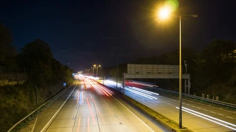 Time lapse night motion light trails on a busy freeway 스톡 동영상 107992042