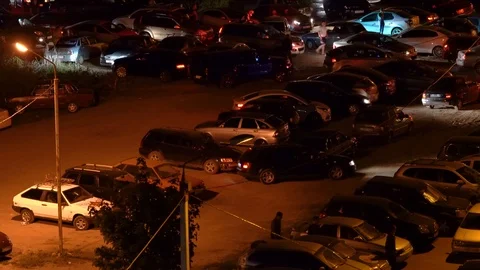 Time lapse night shot of a crowded parking lot emptying out Stock Footage 89611308