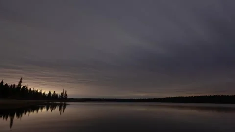 Time lapse of the night sky above a large calm lake.  Stock Footage 281184592