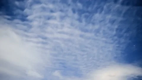 Time-lapse of the night sky with clouds floating from the camera Stock Footage 163278433