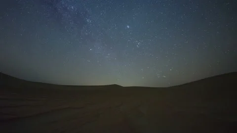 Time lapse of night sky star trail universe in sand dune desert. Stock Footage 237015563
