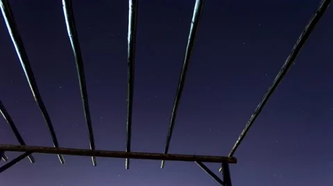 Time-lapse of night sky through roof terrace with wooden beams Stock Footage 51399940