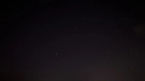 Time lapse at night of star filled sky. Clouds move in over the clear sky Stock Footage 282341054