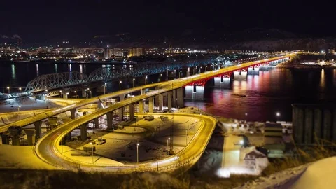 Time lapse of night traffic on the bridge across the river, Russia, Krasnoyarsk Stock Footage 70501935