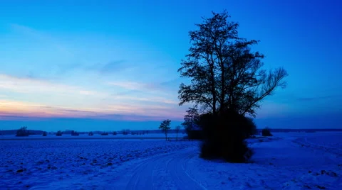 Time-lapse of the nightfall over a snowy landscape Stock Footage 63211240