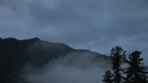 Time lapse of night's arrival in mountains, fog descends on mountains, haze Stock Footage 132737403