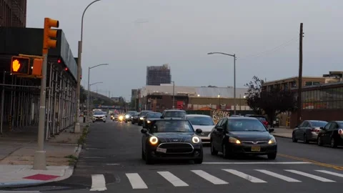 Time-lapse o afterwork traffic approaching &amp; stopping at  stop light Stock Footage 159921755