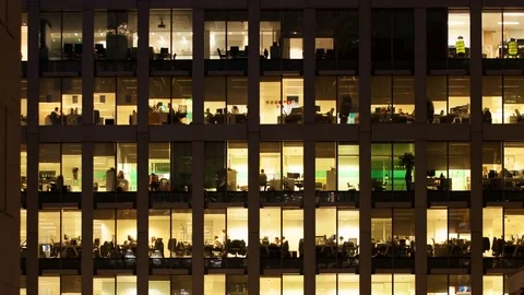 Time-lapse of an office at night panning down to show workers leaving Video stock 71842082