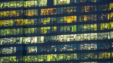 Time-lapse of office workers activity in the windows of modern skyscraper office Stock Footage 86149828