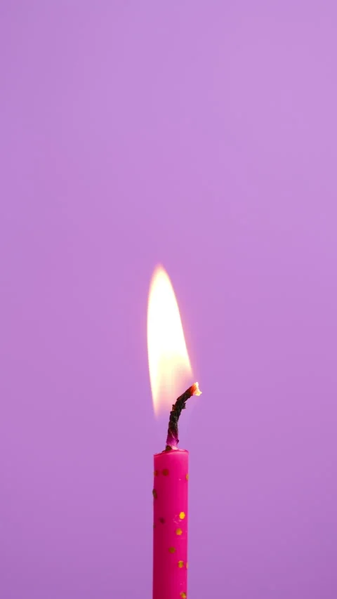 Time lapse of One cake candle burning on a purple background. Close up on Stock Footage 303714914